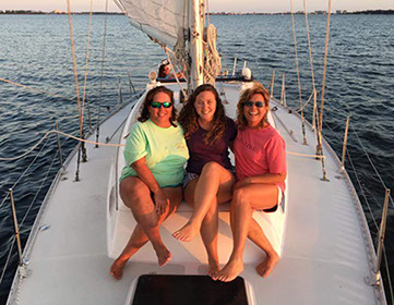 Girls sailing with Back Bay Sailing Adventures.